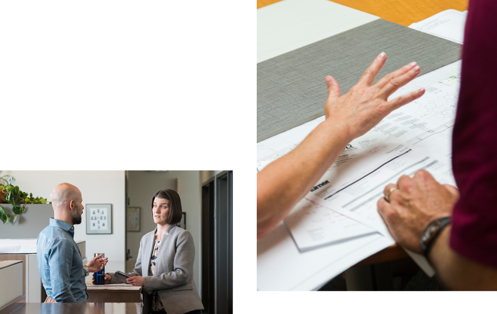 Man and woman speaking in office, a hand over business documents